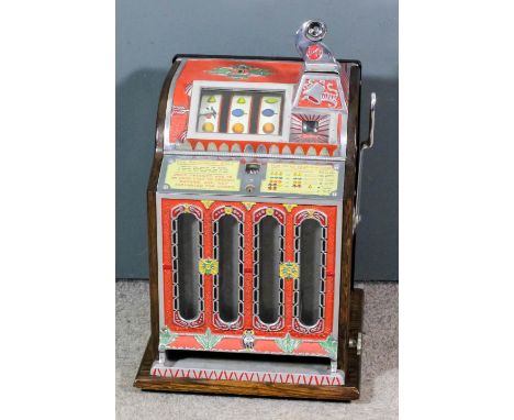 A 1950s American Mills F.O.K. slot machine (to take five Cents), contained in oak case with ornate cast aluminum front with l