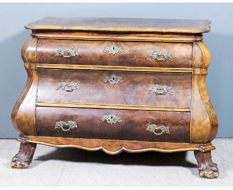 A Dutch walnut bombe fronted commode of "18th Century" design, the shaped top with moulded edge, fitted three long drawers wi