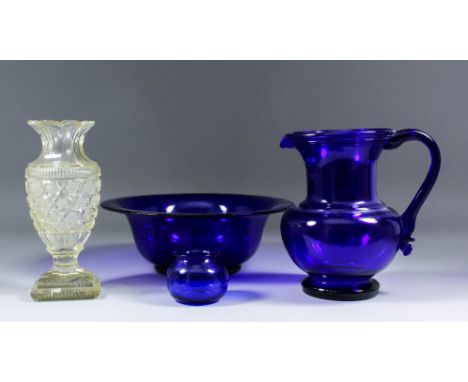 A Bristol blue glass jug with string moulding to under-rim and raspberry prunt to lower handle terminal, 8.25ins high, a matc