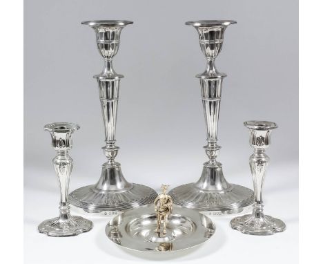 A pair of Edward VII silver oval pillar candlesticks of Neo-Classical fluted form, with urn pattern sconces, tapered stems, o