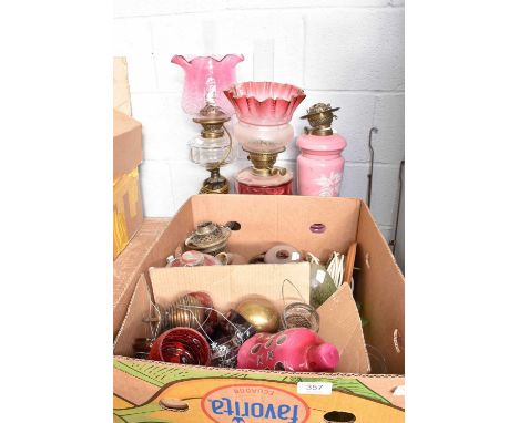 Three Victorian Oil Lamps, including one opaque pink glass example, and another with a cranberry reservoir, together with A B