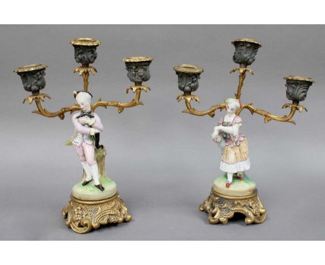 A Pair of 19th Century Porcelain Figural Candelabra, on gilt bases (a.f)