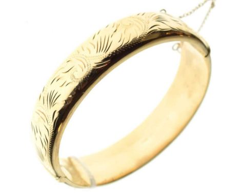 9ct gold snap bangle having foliate engraved decoration, 24.3g approxCondition report: Hallmark slightly rubbed, general ligh