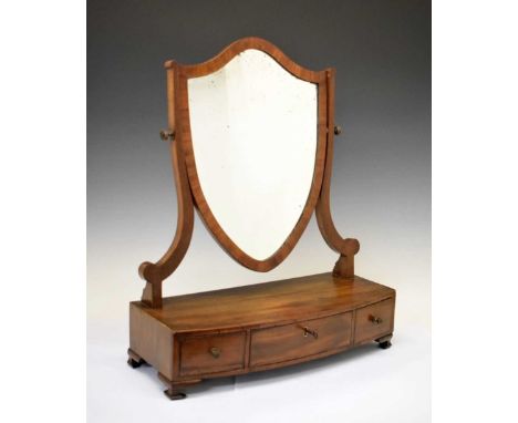 George III mahogany dressing mirror with shield-shaped plate on bowfront box base fitted three drawers, on bracket feet, 51cm