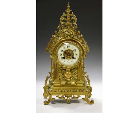 Brass cased French mantel clock, having Arabic dial and central lion head and scroll brass plaque, 43cm high 