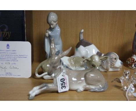 FOUR LLADRO FIGURES, comprising recumbant Donkey and Calf, a Puppy and a boy wrapped in a blanket (4)