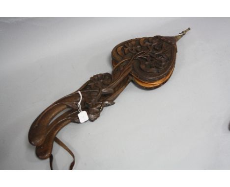 A PAIR OF ORIENTAL STYLE CARVED WOODEN BELLOWS, depicting irises with fish scale carved handles