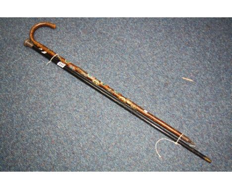 AN EBONISED WALKING CANE WITH A SILVER TOP, London 1903, together with a later walking stick (2)