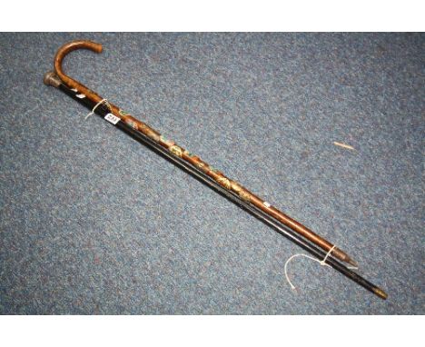 AN EBONISED WALKING CANE WITH A SILVER TOP, London 1903, together with a later walking stick (2)