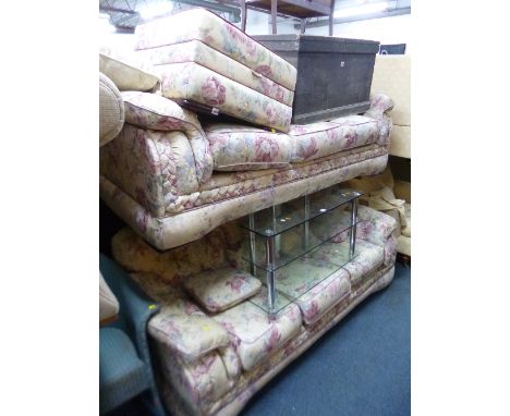 AN UPHOLSTERED THREE PIECE SUITE, comprising of two three seater settees and a pouffe