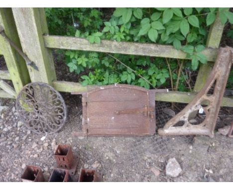 A 19TH CENTURY CAST IRON OVEN/STOVE DOOR WITH FRAME, a cast iron wall bracket, etc (sd) (3)