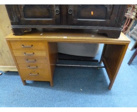 A LIGHT OAK DESK WITH FIVE DRAWERS