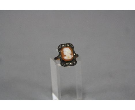 A MID- 20TH CENTURY SHELL CAMEO AND MARCASITE DRESS RING, ring size K, stamped '9ct and Sil', gross weight approximately 2.6 