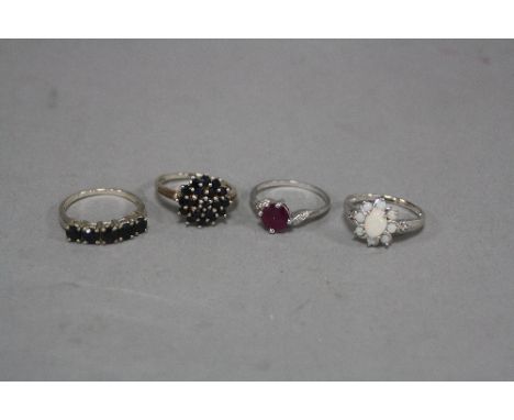 FOUR SILVER DRESS RINGS, including sapphire, ruby, opal, etc, ring sizes O, P, O, O