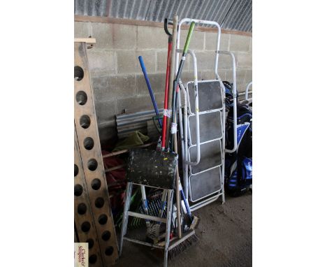 A quantity of long handled garden tools to include metal and plastic rakes, garden loppers, brooms, fork, spade and a small s