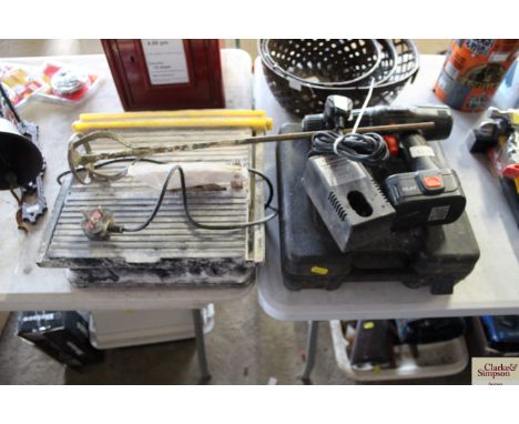 A cordless Wickes drill with battery and charger; a diamond wet tile cutter and a stirrer attachment 