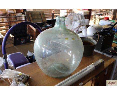 A large vintage glass carboy 