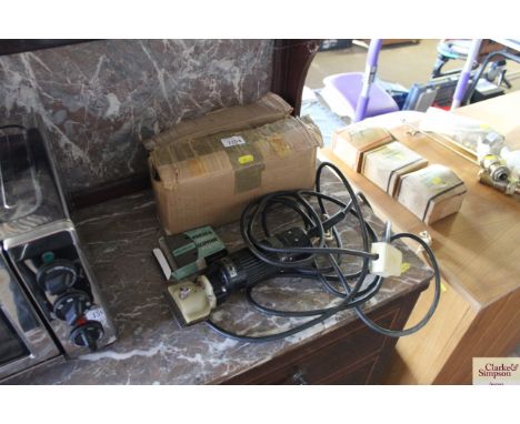 A hand held electric set of horse and cattle clippers with spare clipping plates etc. 
