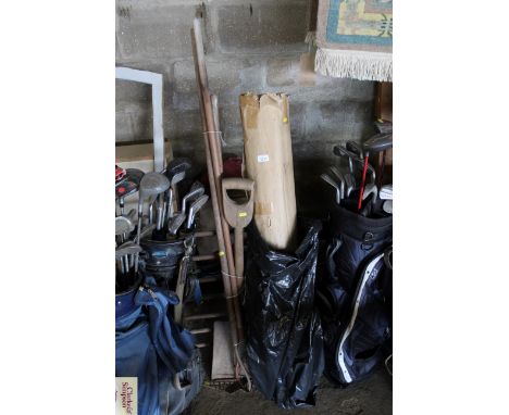 A small quantity of long handled garden tools to include spade, rake, etc; and a quantity of new broom handles 