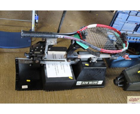 A Bowbrand tennis racket re-stringing machine with tools and accessories 