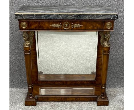 A Theodore Alexander French Empire style flame mahogany console table with marble top and ormolu mounts. Maker's labels to th