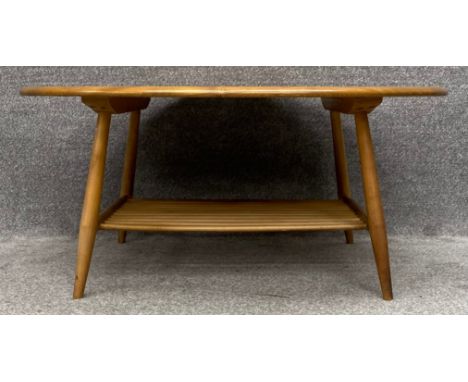 A mid-century Ercol beech and elm oval coffee table, model 454. H.45 W.100 D.83cm
