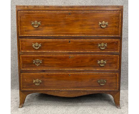 A Regency mahogany and satinwood inlaid chest with fitted secretaire section above three long graduating drawers on swept bra