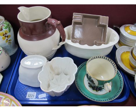Three Jelly Moulds, a XIX Century jug, Poole ashtray, Welsh costume cup and saucer:- One Tray.