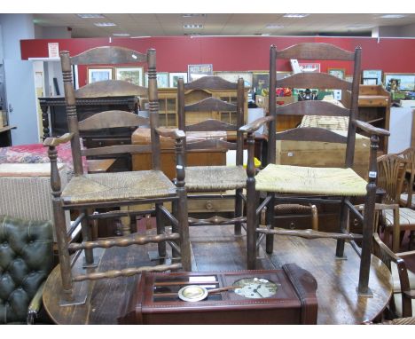 An Early XIX Century Ash and Elm Ladder Back Armchair, with shaped arms and rushed seat on turned round legs united by stretc