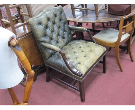 A Faded Green Leather Armchair, with a button back and seat, shaped arms on chamfered legs, united by stretchers.