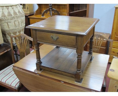 An Oak Lamp Table, with single drawer and under shelf, united by turned and block supports, 53.5cm wide.