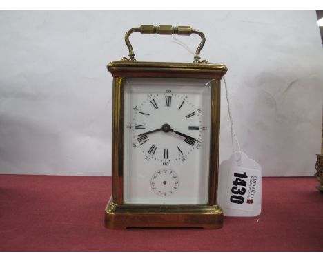 A Brass Carriage Clock, with subsidiary seconds dial to enamelled face, 8cm wide.