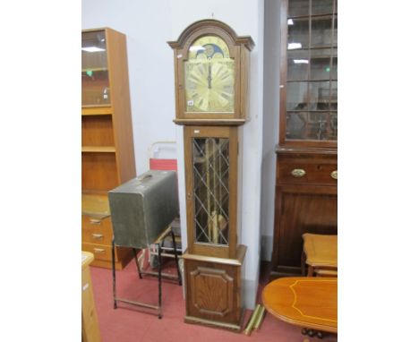 An Oak Cased Moon Faced Grandmother Clock, with a glazed leaded door, panelled base, on bracket feet.