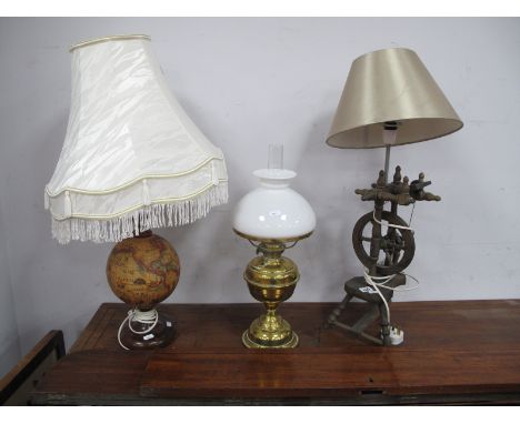 A Brass Oil Lamp, having white glass shade, globe and spinning wheel themes lamps. (3)