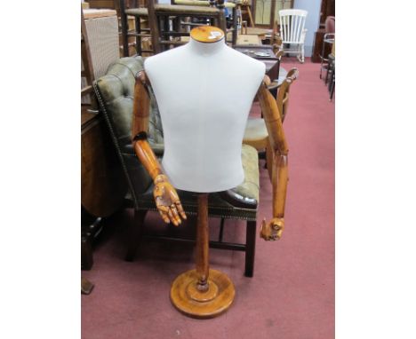 An Adjustable Mannequin, on a circular base, (three fingers missing).