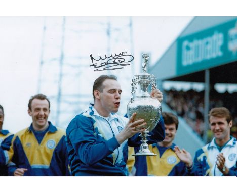 Football Autographed Mel Sterland 12 X 8 Photo: Col, Depicting Leeds United Full-Back Mel Sterland Holding Aloft The First Di