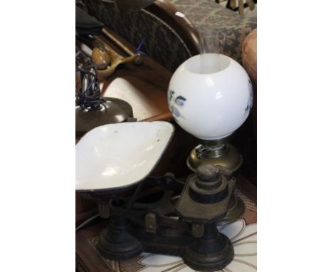 A converted oil lamp, another lamp and a vintage cast iron set of kitchen scales