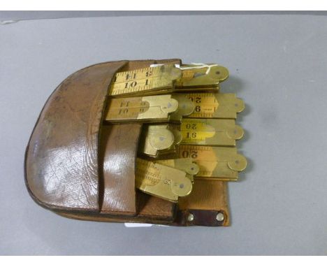 Vintage carpenters tool pouch with 11 boxwood and brass folding rulers