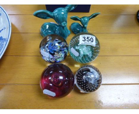 Four Caithness glass paperweights, along with two Poole style Donkeys 