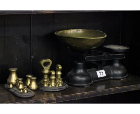 A set of brass scales, along with two set of weights