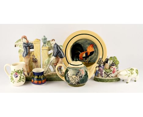 RYE POTTERY, a pair of pottery Staffordshire style flat back figures of golfers, printed mark to base, 26cm high, together wi