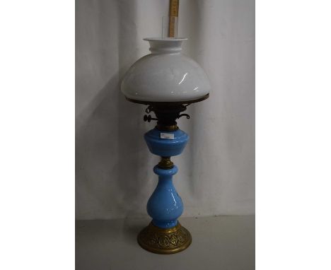 An oil lamp with pale blue base