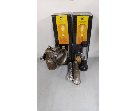 A mixed lot to include a Joseph Lucas Calcia Club bicycle lamp, together with vintage flash lights and four light bulbs A/FLo