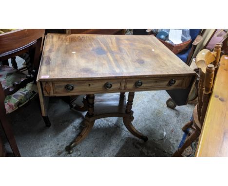 A Regency sofa table with two short drawers with quatrefoil base (leaf bowed) and brass castors 73cm x 92cm (unextended) x 15