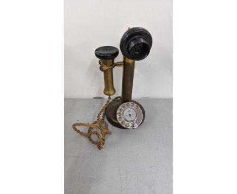 An early/mid 20th century brass candlesticks Rotary dial telephoneLocation: 