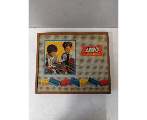 A boxed set of vintage Lego building blocks, windows and boardsLocation: 