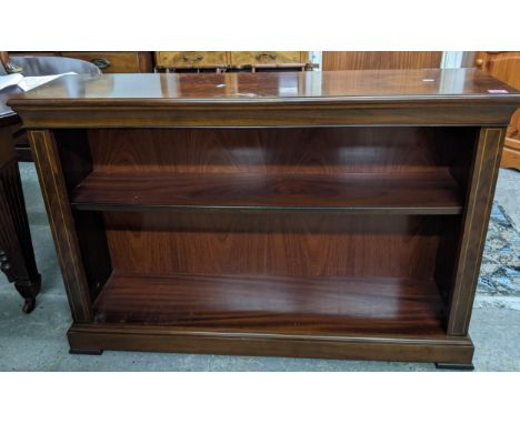 A reproduction mahogany open bookcase with inlaid string decoration, one adjustable shelf on plinth base and block feet 83x12