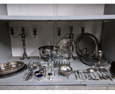 A quantity of silver plate to include a pair of three-branch table candelabras, various cruet sets, trays, a punch bowl and l