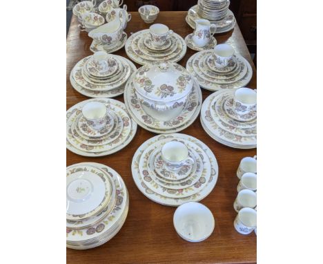 A Wedgwood dinner/tea service in the Lichfield pattern to include two platters, a treen, coffee cans and saucers, dinner plat