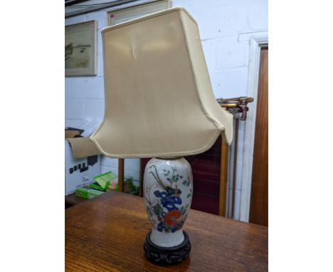 A Chinese late Qing dynasty porcelain vase, converted on a table lamp, fanciful bird perched amongst flowering plants and bus